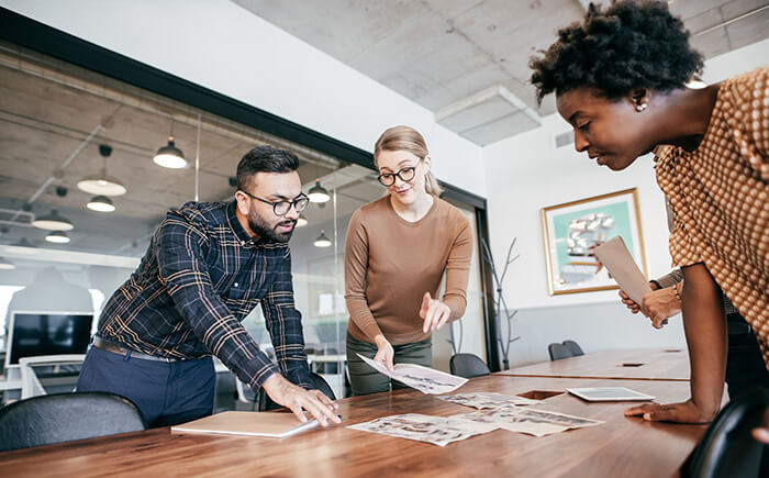 Diverse team of lean consultants working together in office conference room