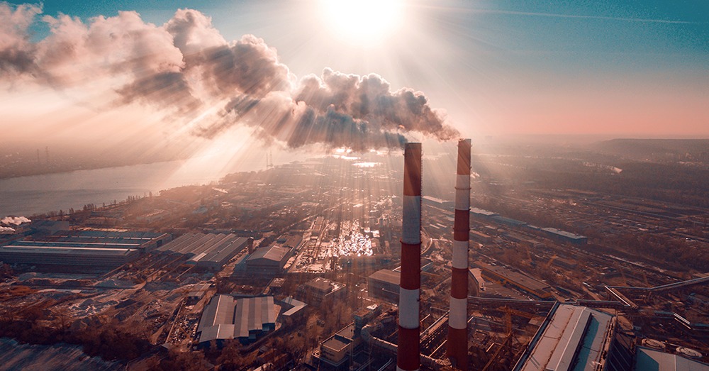 Smokestacks in city near river