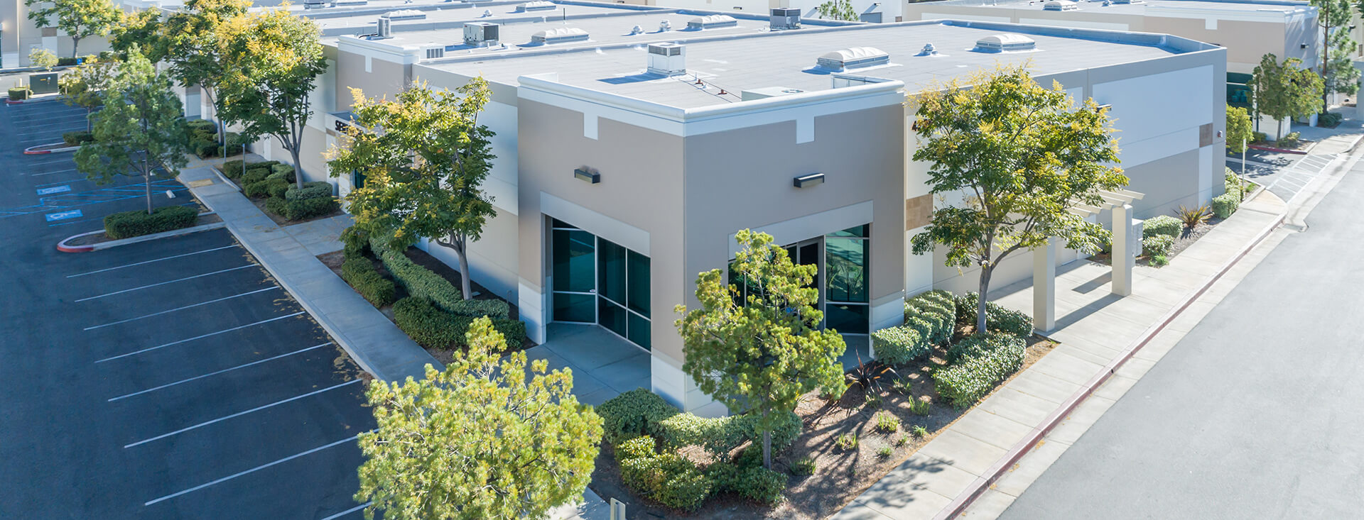 Image of buildings in commercial area surrounded by trees.