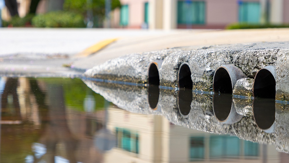 Photo of water flowing into sewage drains.