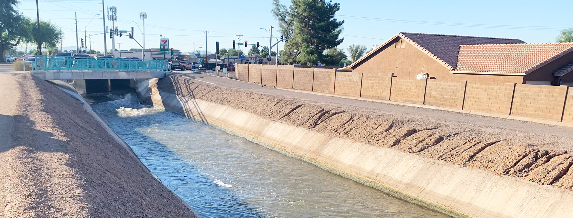 Photo of salt river flowing under a bridge next to a neighborhood.