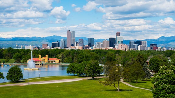 Park with skyline of Denver and mountains in background.
