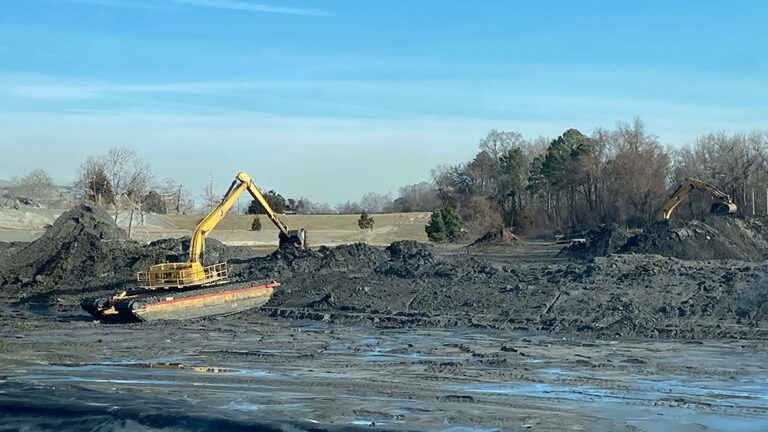 Amphibious excavator excavating an ash pond.