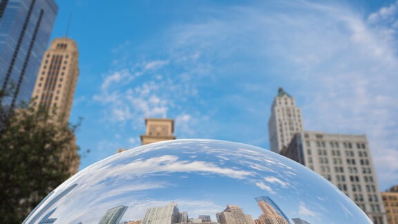 Downtown skyscrapers reflected in the mirror surface of The Bean sculpture in illennium Park in Chicago.