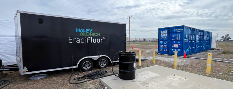 An EradiFluor trailer on-site next to an Allonnia shipping container.