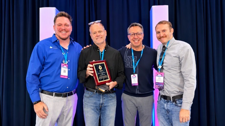 Murray Einarson holds his GRA Lifetime Achievement Award beside R.T. van Valer, Elie Haddad, and Erik Cadaret.